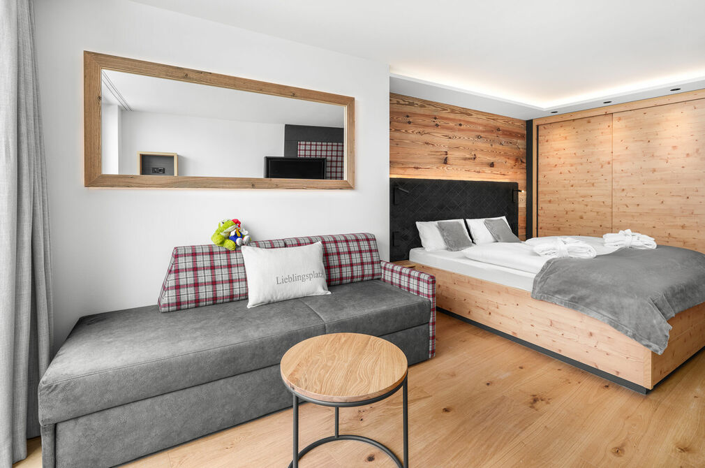 Kinderhotel Allgäuer Berghof – Wohnzimmer Familien-Suite Schafgemach mit Blick auf die Allgäuer Alpen